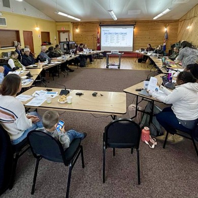 A photo included in a consultation report shows residents at an October 2024 meeting in Norman Wells about the proposed Mackenzie Valley Highway.